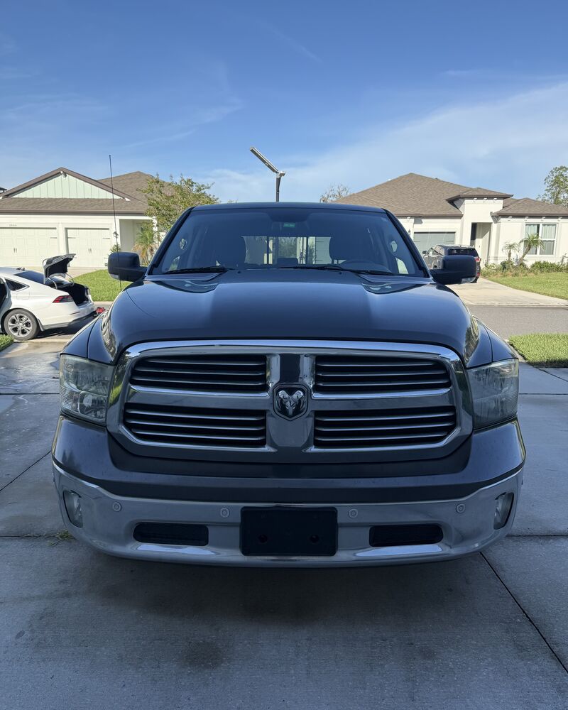 Dark gray Ram 1500 front end cleaned and shining after detailing